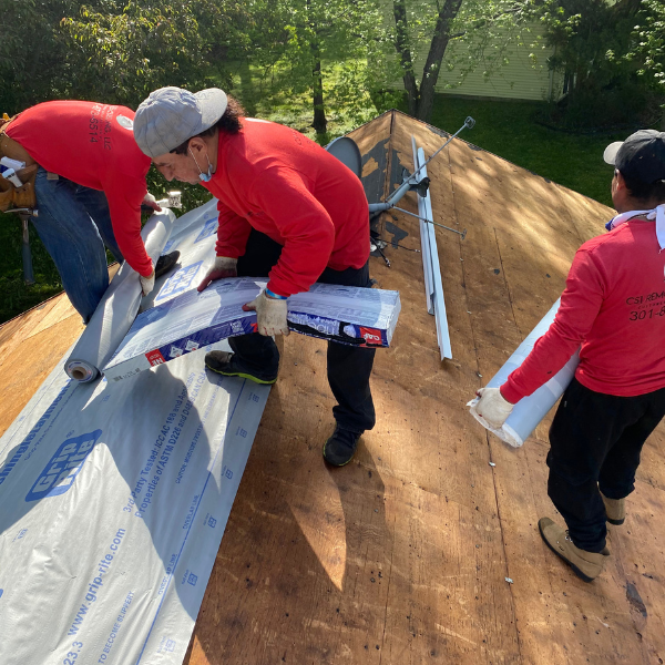 CS1 Construction crew installing roof underlayment on a residential re-roof in Maryland.